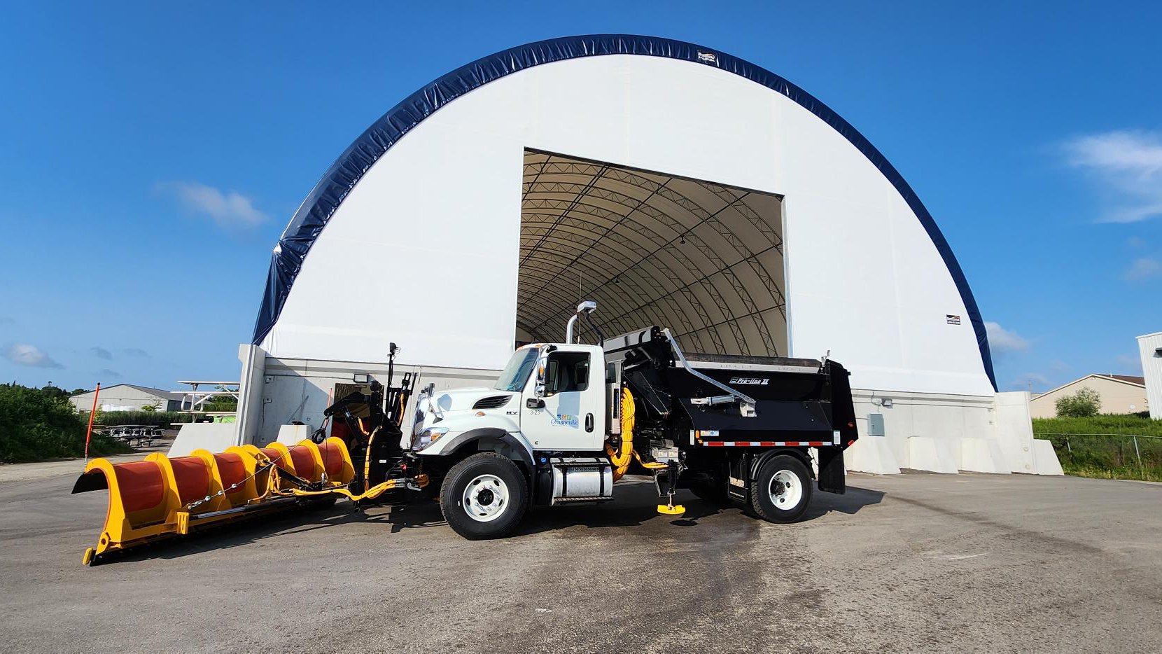 A snow plow in front of the salt dome at the Town of Orangeville Operation Centre